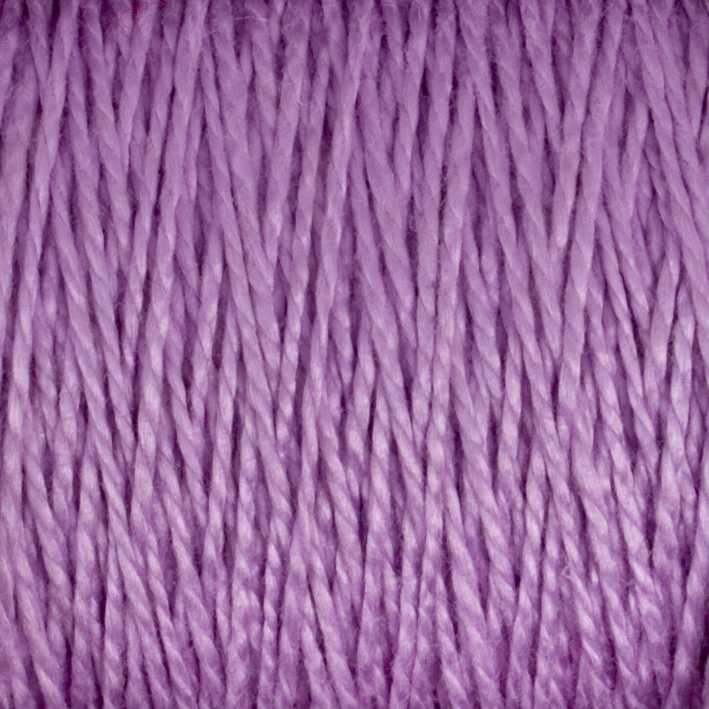 Close-up of Supreme Corp's 5/2 Pearl Cotton Yarn on a large cone, featuring tightly wound light purple fibers. The mercerized cotton yarn radiates a soft and slight sheen, with individual strands interweaving to form a thick, cohesive bundle. The color is uniform throughout, showcasing a gentle pastel hue. Ideal for anyone seeking versatile yarn options.