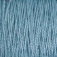 A close-up of the Supreme Corp 5/2 Pearl Cotton Yarn on a mini-cone showcases its tightly wound, light blue mercerized cotton strands in fine detail. The image captures the fibrous texture, with individual threads and subtle color variations clearly visible, making it perfect for weaving projects.