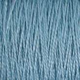 A close-up of the Supreme Corp 5/2 Pearl Cotton Yarn on a mini-cone showcases its tightly wound, light blue mercerized cotton strands in fine detail. The image captures the fibrous texture, with individual threads and subtle color variations clearly visible, making it perfect for weaving projects.