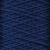 Close-up view of a spool of dark blue 5/2 Pearl Cotton Yarn from Supreme Corp. The tightly wound threads on the large cone form a crisscross pattern, creating an intricate texture. The image highlights the fibers and details of this versatile yarn.