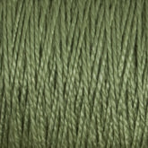 A close-up view of Supreme Corp's 5/2 Pearl Cotton Yarn on a mini-cone showcases its tightly spun fibers and slightly glossy texture. The uniform strands create a textured, woven appearance, with a consistent medium green shade ideal for intricate weaving projects.