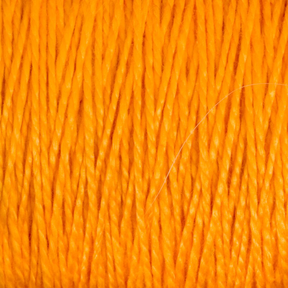 Close-up image of Supreme Corp's 5/2 Pearl Cotton Yarn | Large Cone, featuring tightly wound strands of bright orange mercerized cotton. The texture and vibrant color are prominently showcased, with individual fibers clearly visible, highlighting the smooth and slightly glossy surface of this versatile yarn.