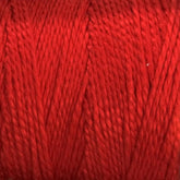 Close-up image of 5/2 Pearl Cotton Yarn by Supreme Corp, wound tightly on a large cone. The texture of the red mercerized cotton fibers is visible, showcasing a smooth and slightly glossy finish. The strands are uniformly twisted, creating a consistent and even appearance.