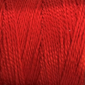 Close-up image of 5/2 Pearl Cotton Yarn by Supreme Corp, wound tightly on a large cone. The texture of the red mercerized cotton fibers is visible, showcasing a smooth and slightly glossy finish. The strands are uniformly twisted, creating a consistent and even appearance.