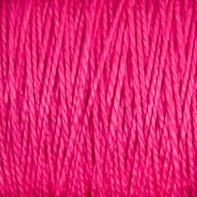 Close-up view of thick, pink, 5/2 Pearl Cotton Yarn from Supreme Corp densely wrapped together, showing textured strands and fibers intertwined.