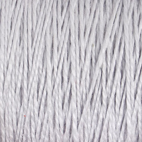 Close-up of tightly wound, light-colored 5/2 Pearl Cotton Yarn from Supreme Corp, displaying a soft and fibrous texture. The strands are neatly aligned on the large cone, forming a uniform pattern that captures the fluffiness and smoothness of this versatile yarn material.