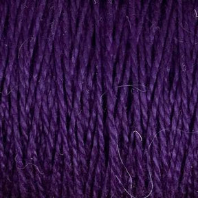 Close-up of Supreme Corp's 5/2 Pearl Cotton Yarn in purple, showcasing tightly woven strands and varying shades that create a textured appearance. Some loose fibers are visible, adding intricate detail to the yarn on the large cone.