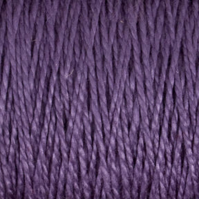 A close-up image showcases the smooth, twisted strands of Supreme Corp's 5/2 Pearl Cotton Yarn | Large Cone in a rich purple hue. This mercerized cotton yarn is versatile and appears densely wound, with consistent color and texture throughout.