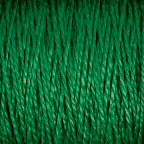 Close-up image of multiple green threads from Supreme Corp's 5/2 Pearl Cotton Yarn running vertically. The tightly packed threads create a textured pattern, with the vibrant green hue subtly reflecting light. This emphasizes the individual fibers' strands and showcases the versatility of this premium yarn available in large cones.