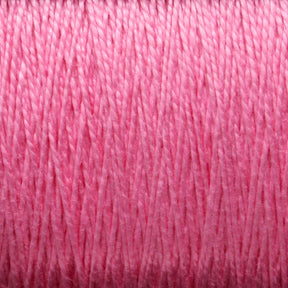 Close-up texture of Supreme Corp's 5/2 Pearl Cotton Yarn | Large Cone in pink, showing the tightly wound strands in detail.