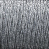 Close-up view of a tightly wound, light gray spool of Supreme Corp's 5/2 Pearl Cotton Yarn on a large cone, showing the individual strands and textures. The fibers appear uniform and smooth, with a slight sheen.