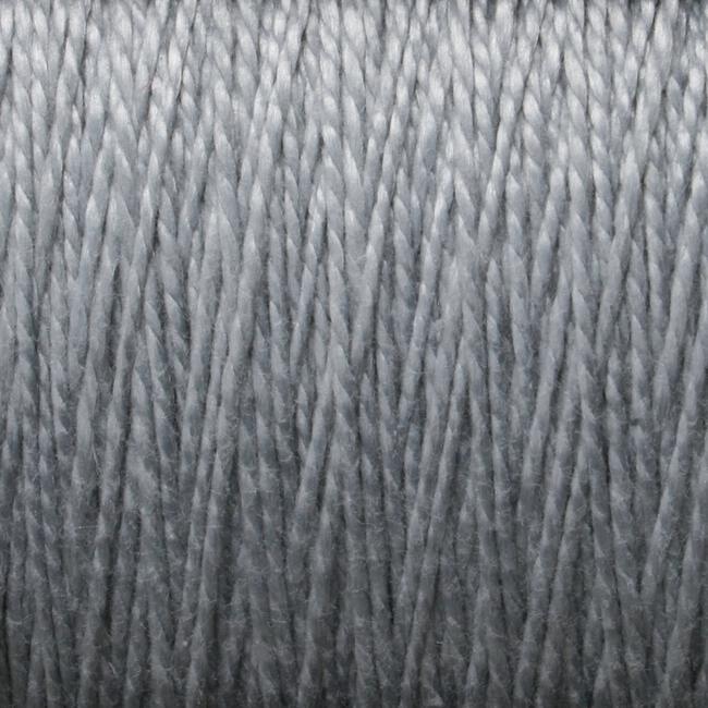 Close-up view of a tightly wound, light gray spool of Supreme Corp's 5/2 Pearl Cotton Yarn on a large cone, showing the individual strands and textures. The fibers appear uniform and smooth, with a slight sheen.