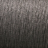 Close-up view of a large cone of 5/2 Pearl Cotton Yarn by Supreme Corp, showcasing tightly wound strands with a slight sheen, providing a detailed texture of the gray mercerized thread fibers.