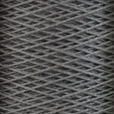 Close-up image of a large cone of Supreme Corp's 5/2 Pearl Cotton Yarn, tightly wound in a crisscross pattern. The textured gray fibers have a slightly glossy finish, reminiscent of mercerized cotton yarn. The yarn appears sturdy and versatile, likely used for knitting or weaving.