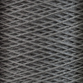 Close-up of a spool of gray 5/2 Pearl Cotton Yarn | Mini-cone by Supreme Corp, showcasing intricate crisscrossing threads wound tightly. The texture highlights the fibrous quality of the mercerized cotton yarn, ideal for weaving projects. The image emphasizes the pattern and texture of the material, perfect for detailed craftsmanship.