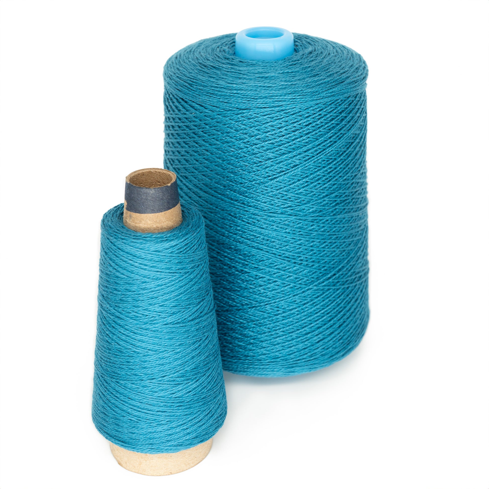 Two mini-cones of turquoise 5/2 Pearl Cotton Yarn from Supreme Corp, ideal for weaving projects, are displayed upright. The larger cone has a blue plastic core and stands behind the smaller one with a cardboard core. Both cones are tightly wound, showcasing the vibrant color and texture of the pearl cotton yarn.