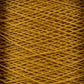 Close-up view of a spool of tightly wound, golden-yellow thread. The crisscross pattern of the 10/2 Pearl Cotton Yarn | Large Cone from Supreme Corp. is clearly visible, showcasing its texture and density. The color and detail highlight the thread's smooth, fibrous quality.