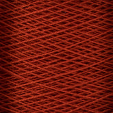 Close-up image of a large cone of red 10/2 Pearl Cotton Yarn by Supreme Corp., showcasing the fine texture and overlapping pattern of the tightly wound fibers. The image reveals a uniform and intricate crisscross design, highlighting the smooth and consistent appearance of this versatile yarn.