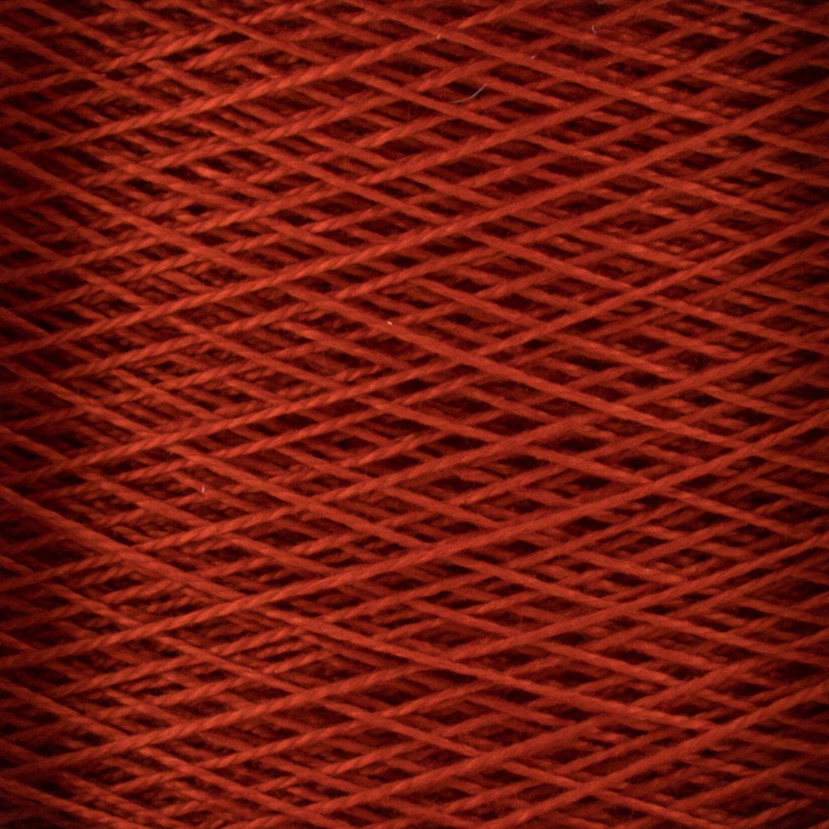 Close-up image of a large cone of red 10/2 Pearl Cotton Yarn by Supreme Corp., showcasing the fine texture and overlapping pattern of the tightly wound fibers. The image reveals a uniform and intricate crisscross design, highlighting the smooth and consistent appearance of this versatile yarn.