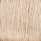 Close-up image of tightly wound, light beige-colored 10/2 Pearl Cotton Yarn from Supreme Corp. The texture is smooth with visible strands, conveying both softness and strength. This versatile yarn resembles natural fibers like cotton or linen and promises to be colorfast for lasting vibrancy, making it an excellent choice for various projects.