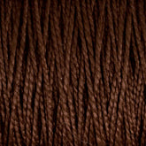 Close-up image of dark brown 10/2 Pearl Cotton Yarn from Supreme Corp. on a large cone, showcasing tightly twisted strands. The texture highlights the neatly wound fibers, forming a pattern of parallel lines. This versatile yarn provides a colorfast finish, making it ideal for various craft projects.