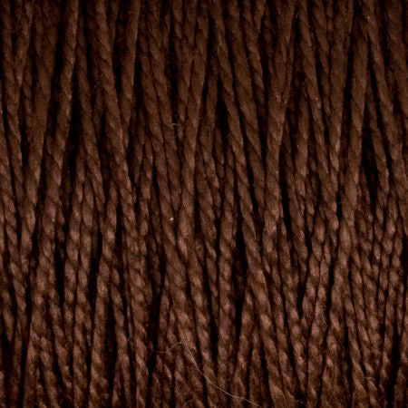 Close-up image of dark brown 10/2 Pearl Cotton Yarn from Supreme Corp. on a large cone, showcasing tightly twisted strands. The texture highlights the neatly wound fibers, forming a pattern of parallel lines. This versatile yarn provides a colorfast finish, making it ideal for various craft projects.