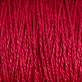 Close-up image of bright red 10/2 Pearl Cotton Yarn strands tightly packed together. The texture of these colorfast fibers by Supreme Corp. appears smooth and slightly lustrous, with a uniform thickness throughout, showcased on a large cone.