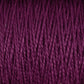 Close-up image of the deep purple 10/2 Pearl Cotton Yarn from Supreme Corp. tightly wound together on a large cone, showcasing the intricate texture of the colorfast fibers.