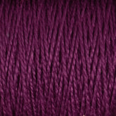 Close-up image of the deep purple 10/2 Pearl Cotton Yarn from Supreme Corp. tightly wound together on a large cone, showcasing the intricate texture of the colorfast fibers.