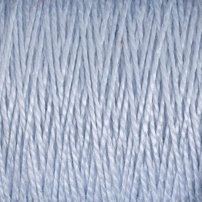 Close-up view of Supreme Corp.'s 10/2 Pearl Cotton Yarn on a large cone in light blue, showcasing the tightly wound strands in a vertical pattern. The texture appears soft and smooth, with a slight sheen reflecting light. This versatile yarn is perfect for various crafting projects.