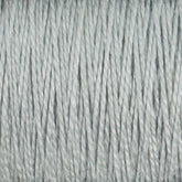 Close-up image of light gray 10/2 Pearl Cotton Yarn strands from Supreme Corp., tightly grouped together, showing their texture and twisted fibers. This versatile yarn appears soft, even in thickness, and colorfast.