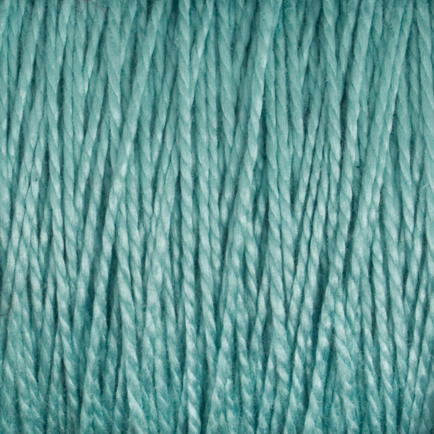 Close-up image of soft, aqua-colored 10/2 Pearl Cotton Yarn strands from Supreme Corp., lined up vertically to showcase the texture and woven fibers in detail. The light catches the versatile yarn's surface, giving it a slightly glossy appearance and highlighting its colorfast quality.