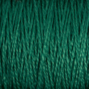 Close-up image of Supreme Corp.'s 10/2 Pearl Cotton Yarn in green. The fibers intertwine, creating a textured pattern with varying shades of green, indicating thickness and softness. This colorfast and versatile yarn, available in a large cone, is perfect for any project.