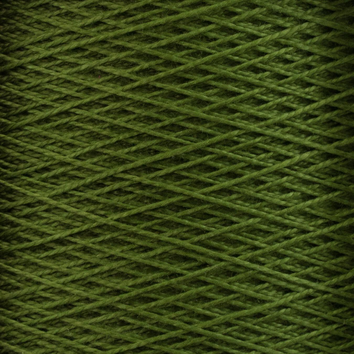 Close-up image of a spool of Supreme Corp.'s 10/2 Pearl Cotton Yarn in green, showcasing tightly wound threads that form a crisscross pattern. The colorfast yarn exhibits uniform coloring, with neatly aligned strands.