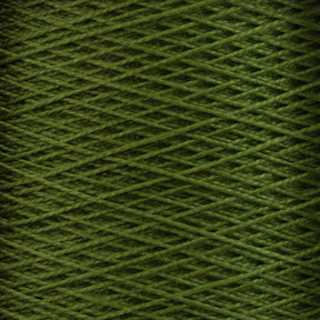 Close-up image of a spool of Supreme Corp.'s 10/2 Pearl Cotton Yarn in green, showcasing tightly wound threads that form a crisscross pattern. The colorfast yarn exhibits uniform coloring, with neatly aligned strands.