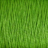 Close-up image of neatly wound, bright green 10/2 Pearl Cotton Yarn by Supreme Corp. The versatile yarn fibers are tightly packed, creating a highly textured and detailed appearance while remaining colorfast.