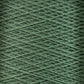 Close-up image of a green spool of Supreme Corp.'s 10/2 Pearl Cotton Yarn on a large cone. The yarn is tightly wound in a crisscross pattern, creating a textured surface with varied shades of green. The overall effect is a detailed and intricate display of the yarn's fibers and colorfast structure.