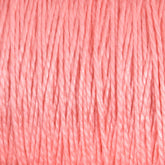 Close-up of light pink twisted yarn strands, tightly packed together in a uniform pattern, showcasing the texture and slight sheen of the colorfast fibers from Supreme Corp.'s 10/2 Pearl Cotton Yarn on a large cone.