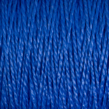 Close-up image of the 10/2 Pearl Cotton Yarn from Supreme Corp., showing tightly wound, versatile thread with individual strands twisted together and a textured surface. The color is a rich, vibrant blue with a subtle sheen.