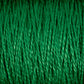 A detailed close-up of Supreme Corp.'s 10/2 Pearl Cotton Yarn on a large cone reveals the texture and intertwining strands. This colorfast yarn showcases a smooth, tightly spun structure with a consistent and vibrant green hue throughout.