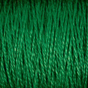 A detailed close-up of Supreme Corp.'s 10/2 Pearl Cotton Yarn on a large cone reveals the texture and intertwining strands. This colorfast yarn showcases a smooth, tightly spun structure with a consistent and vibrant green hue throughout.