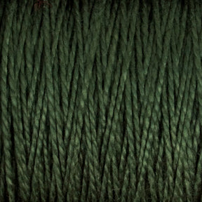 Close-up shot of the 10/2 Pearl Cotton Yarn | Large Cone by Supreme Corp. in dark green, highlighting the detailed texture and uniformly tight strands. The versatile yarn exhibits a subtle glossy sheen as light reflects off its fibers, showcasing a tightly woven and consistent pattern.