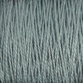 Close-up of a textured surface made from tightly spun 10/2 Pearl Cotton Yarn by Supreme Corp., in a soft, muted grayish-blue color. The versatile yarn strands are parallel, creating a consistent pattern throughout the image.