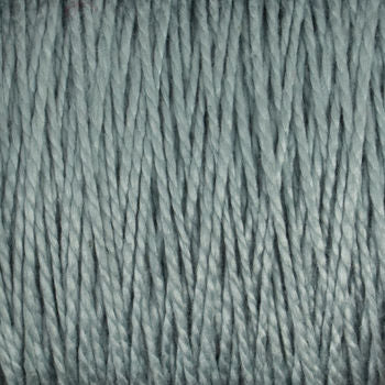 Close-up of a textured surface made from tightly spun 10/2 Pearl Cotton Yarn by Supreme Corp., in a soft, muted grayish-blue color. The versatile yarn strands are parallel, creating a consistent pattern throughout the image.