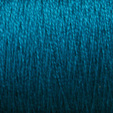 A close-up of the Supreme Corp. 10/2 Pearl Cotton Yarn in vibrant blue, showcasing the detailed texture of the intertwined threads. The colorfast quality is rich and consistent throughout, highlighting the fine fibers of this large cone yarn.