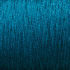 A close-up of the Supreme Corp. 10/2 Pearl Cotton Yarn in vibrant blue, showcasing the detailed texture of the intertwined threads. The colorfast quality is rich and consistent throughout, highlighting the fine fibers of this large cone yarn.