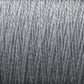 Close-up of a spool of silver-grey 10/2 Pearl Cotton Yarn from Supreme Corp., tightly wound with a smooth texture and uniform thickness. The fibers appear slightly shiny, adding a metallic sheen to the versatile yarn's overall appearance.