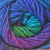 A close-up of Kureyon by Noro handspun yarn from Knitting Fever / Euro Yarns tightly wound into a spiral formation. The yarn features a gradient of vibrant colors, including shades of blue, green, pink, and purple, creating an eye-catching woolly texture perfect for unique intarsia designs.