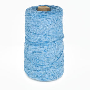 A large cone of Halcyon Yarn's Casco Bay Cotton Chenille in light blue is standing upright on a white background. The thick and fluffy yarn, ideal for knitting or weaving projects, is wound tightly around a cardboard core in the center. This soft and textured Casco Bay Cotton Chenille adds a touch of luxury to any creation.