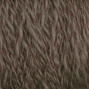 Close-up of Halcyon Yarn's Block Island Blend | Large Cone yarn, a thick, fibrous mix spun and dyed in Maine. Featuring earthy tones like grey and brown, the yarn boasts a visibly soft and slightly fluffy texture with twisted strands.